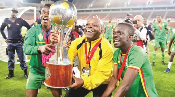 Former manager Sunday Chidzambwa lifts the COSAFA cup with his Warriors squad