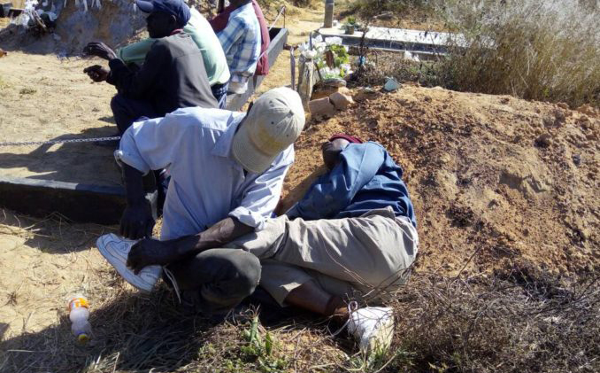 File picture of a man caught sleeping on a grave. He reportedly blamed it on musombodhiya (illicit beer brew)