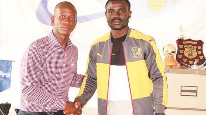DONE DEAL . . . Cameroon international striker Christian Epoupa (right), seen here with Footballers Union of Zimbabwe secretary-general Thomas ‘’Rambo’’ Sweswe, has joined Botswana club Orapa United