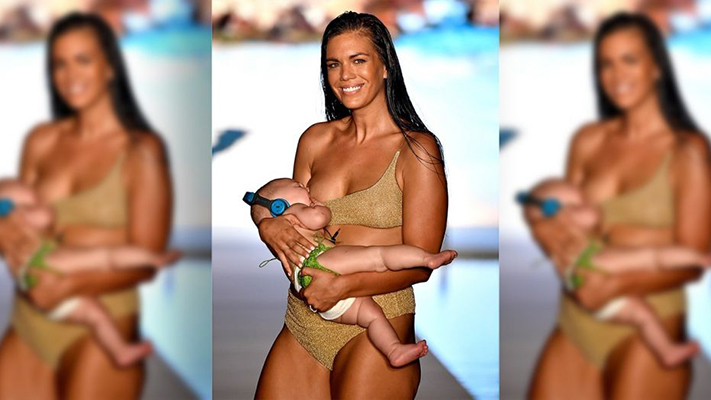 Mara Martin held her five-month-old daughter Aria at Sports Illustrated's annual swimsuit show on Sunday.