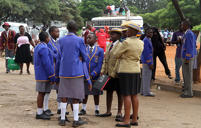 Ordinary Level students from Bradley High School have time to chat while waiting for to board the bus back to school from Harare - Picture by Kudakwashe Hunda