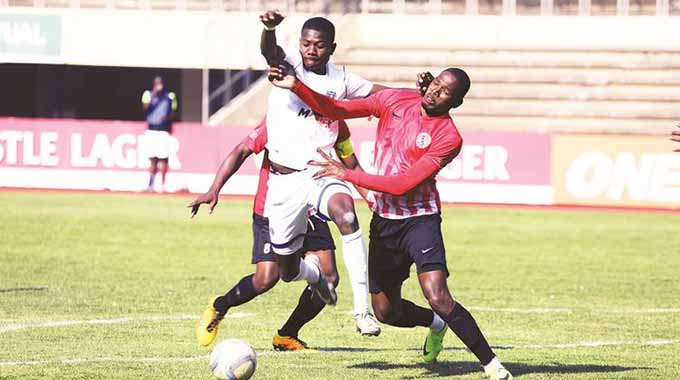 CHECK MATE . . . Dynamos forward Tawanda Macheke (left) battles for possession against Yadah’s Byron Madzokere while Brian Mapfumo (partly obscured) monitors the situation in yesterday’s match at the National Sports Stadium