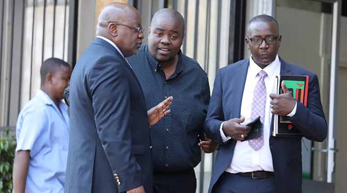 Wicknell Chivayo chats to his lawyers Advocate Lewis Uriri (right) and Mr Wilson Manase at the court yesterday