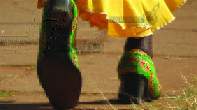 A lady at the inauguration ceremony with shoes matching her party regalia