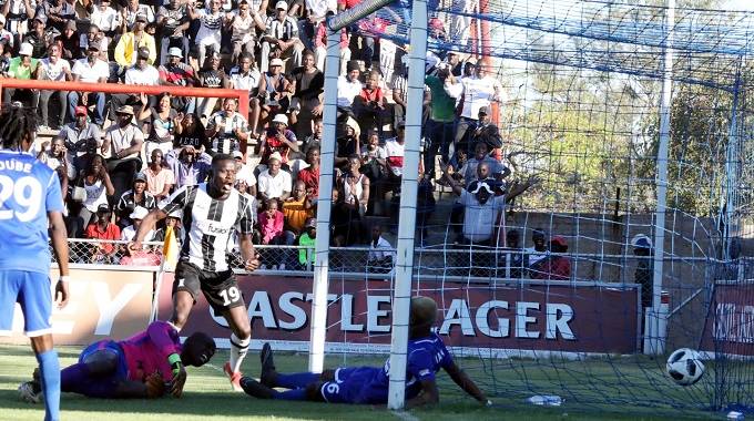 Tendai Ndlovu of Highlanders watches as a header from Gabriel Nyoni hits the target