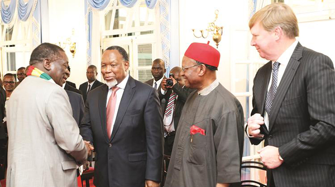President Emmerson Mnangagwa congratulates members of the Commission of Inquiry into the post-election violence (from left) chairperson and former South African President Kgalema Motlanthe, former Commonwealth secretary-general and Nigerian national Chief Emeka Anyaouku, and UK-based Queen’s Counsel Rodney Dixon (right) after their swearing in ceremony at State House in Harare yesterday. —(Picture by Tawanda Mudimu)