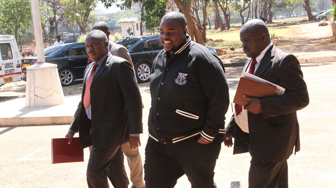Wicknell Chivayo arrives at the Harare Magistrates’ Courts escorted by detectives recently