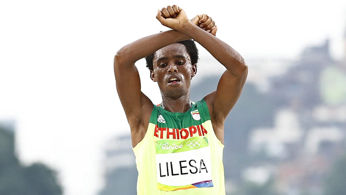 Feyisa Lilesa held his arms over his head, wrists crossed, as he finished second in the marathon in the Rio de Janeiro Olympics, a gesture used by protesters in Ethiopia’s Oromiya region during a period of unrest in 2015-2017.