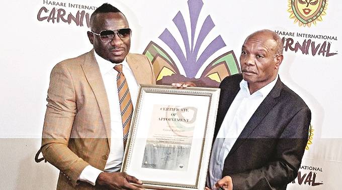 Karikoga Kaseke presents Genius ‘Ginimbi’ Kadungure with brand ambassador certificate on Tuesday