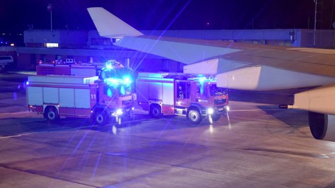 The plane was met on the tarmac in Cologne by emergency vehicles