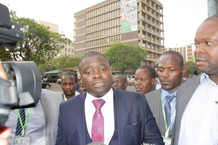 Opposition MDC Alliance MPs outside parliament following the chaos that marked police units forcibly evicting them from the House after they refused to stand up for President Emmerson Mnangagwa