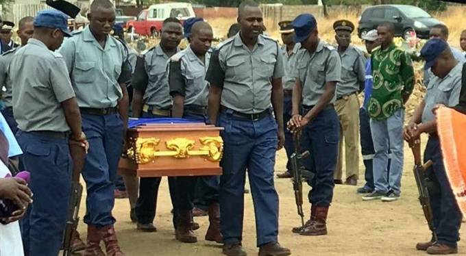 Police pallbearers carry the late Constable Edmond Sibanda’s body