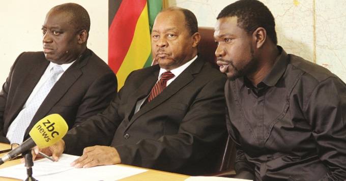 Minister of Health and Child Care, Dr Obadiah Moyo (centre) and his Deputy Dr John Mangwiro (left) listen as PHD Ministries founder Prophet Walter Magaya (right) addresses a Press conference in Harare