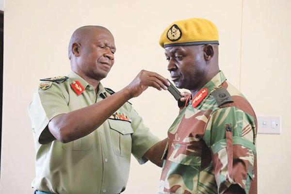 Zimbabwe Defence Forces commander General Philip Valerio Sibanda (left) confers the rank to Presidential Guard commander Major-General Anselem Nhamo Sanyatwe recently