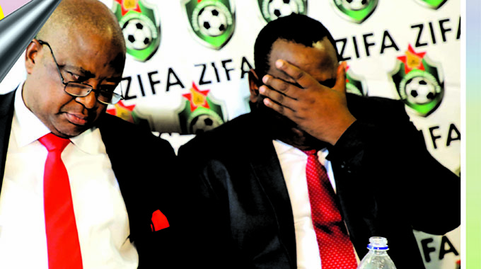 DOWN AND OUT . . . A distraught Philip Chiyangwa (left) and Omega Sibanda show their disappointment after they were ousted as ZIFA bosses during yesterday’s elections in Harare. – Picture by Lee Maidza