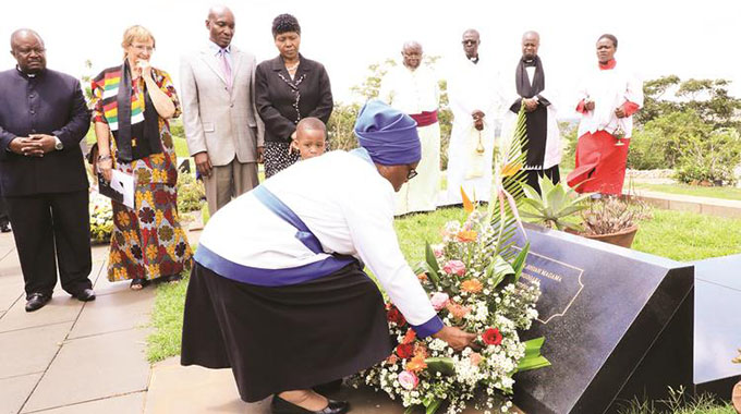 Mrs Angelina Tongogara, the widow of national hero General Josiah Magama Tongogara, lays a wreath on her husband’s grave at the National Heroes Acre in Harare yesterday. Looking on are Defence and War Veterans’ Minister Oppah Muchinguri-Kashiri (fourth from left), Acting Zimbabwe Defence Forces Commander Lieutenant-General Edzai Chimonyo (third from left), Major-General Douglas Nyikayaramba (left). Yesterday was the 39th anniversary of the Zanla Commander’s death. — Picture by Memory Mangombe