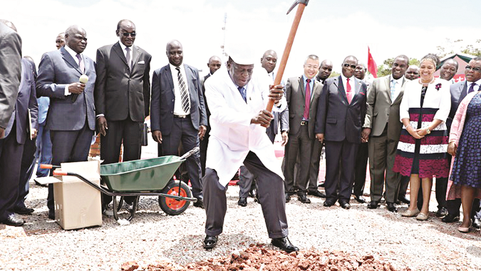 President Mnangagwa digs the foundation of the new Parliament building at a groundbreaking ceremony, while Vice Presidents Constantino Chiwenga (4th right) and Kembo Mohadi (2nd left), China’s Acting Ambassador to Zimbabwe Cde Zhao Baogang, Cabinet Ministers and Government officials look on in Mt Hamptden yesterday. (Picture by Justin Mutenda)