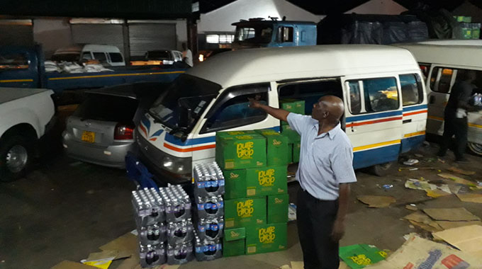 A Harare-based tuck shop takes delivery of its cooking oil in the evening. (Picture by Africa Moyo)