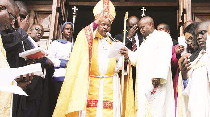 The Anglican Church Diocese of Harare’s new Bishop, Dr Farai Mutamiri (centre) blesses the City of Harare soon after his ordainment at the the Cathedral of St Mary and All Saints— Picture by Kudakwashe Hunda