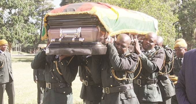 Pallbearers carry the casket of the late Dr Oliver Mtukudzi