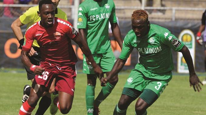 FC Platinum’s Farai Edwin Madhanaga (right) tries to evade Horoya AC’s Amadou Djibo Mohamed during the Caf Champions League match played at Barbourfields Stadium yesterday...Pic By Dennis Mudzamiri