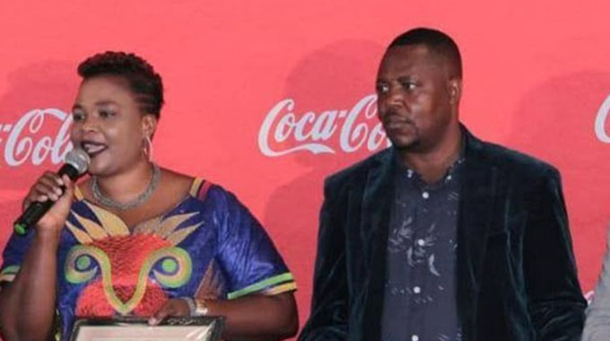 Mai Patai speaks after receiving her Radio Zimbabwe Coca-Cola Top 50 prize in the company of her husband Ephraim Patai
