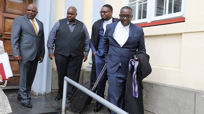 Wicknell Chivayo and his lawyers at the High Court today