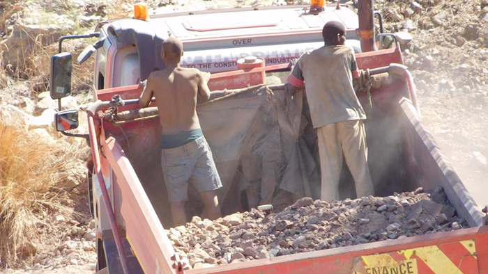 A lorry carries gold ore from the pit at Gaika Mine to a mill for processing