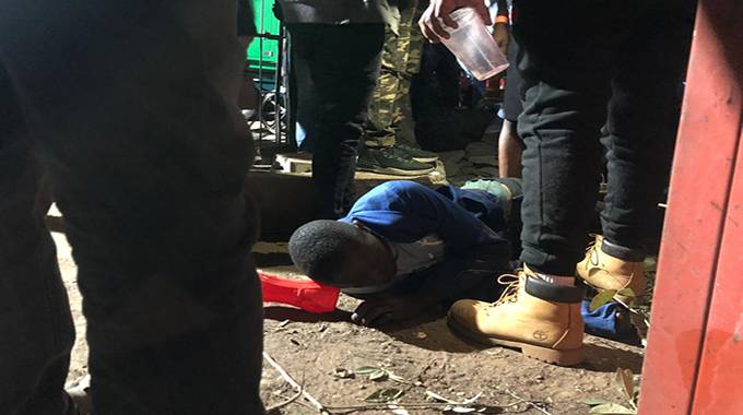 An injured fan lies on the ground at Queens Sports Club on Saturday night