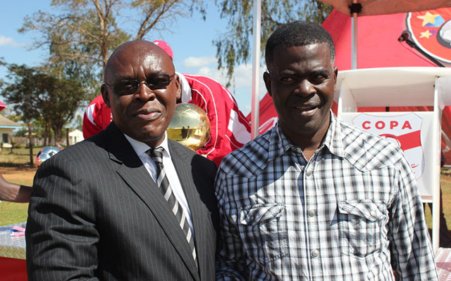Delta Sparkling Beverages general manager Moses Gambiza (left) chats with Mazowe South Member of Parliament Fortune Chasi at the launch of the 2017 Copa Coca-Cola Tournament at Rujeko High School in Glendale