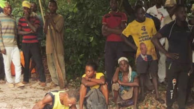 People look on as the rescue effort continues on Lake Mai-Ndombe