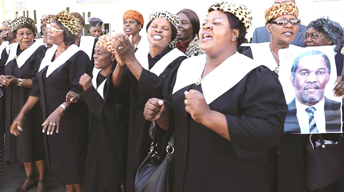 Members of the African Methodist Episcopal Church sing and dance while awaiting the arrival of national hero Dr Dumiso Dabengwa’s body at Joshua Mqabuko Nkomo International Airport in Bulawayo yesterday