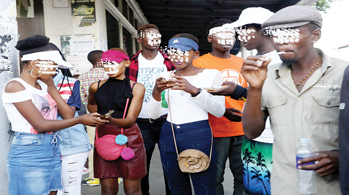 Teens ponder their next move on Saturday in the Bulawayo Central Business District after police deployed officers to deal with and arrest rowdy youths. Over 100 teens were arrested for public nuisance in the city centre