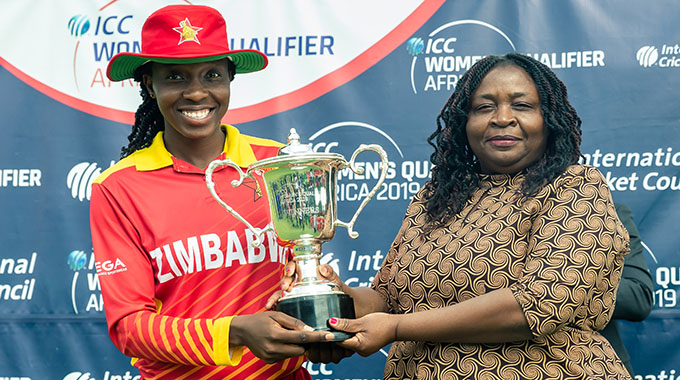 Zimbabwe captain receives the tournament trophy from Mrs Kambarami after winning during a World Cup Cricket Qualifier Final match played with Namibia at Harare Sports Club in Harare, May 12 2019.