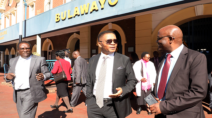 Transport and Infrastructure Development Minister Joel Biggie Matiza(centre) yesterday stresses a point to National Railways of Zimbabwe (NRZ) general manager Engineer Lewis Mukwada after touring the Bulawayo Railway station.