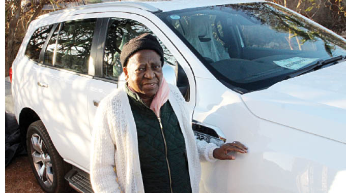 Former First Lady Mrs Janet Madade Banana with her new Ford Everest that she received from Government