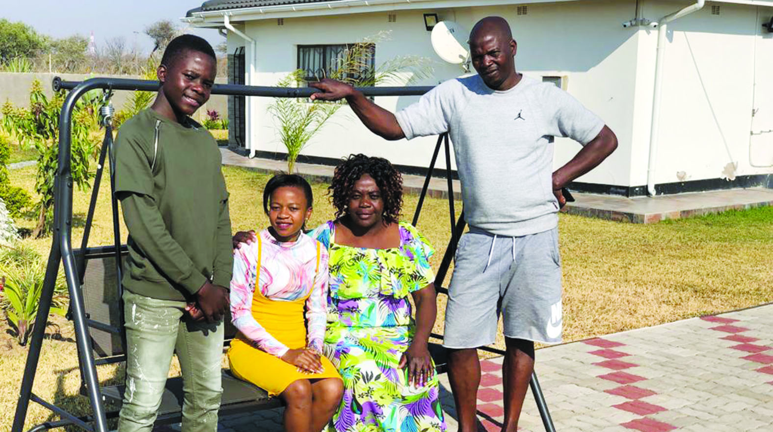 Antony Nakamba Jr (left) , Marvelous’ fiancee Chipo, his mother Charity and father Antony relax at the home that Marvelous bought for them in Bulawayo.
