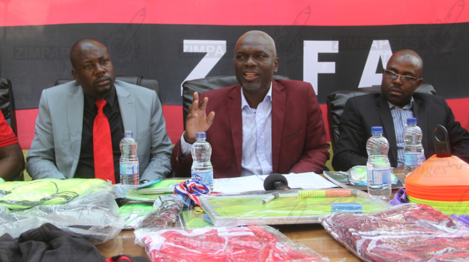 SOLDERING ON . . . ZIFA president Felton Kamambo (centre), flanked by board members Farai Jere (left) and Philemon Machana, addresses the media in Harare yesterday where he said the fierce criticism he has received in his first nine months in office will make him a better leader of the country’s national sporting discipline