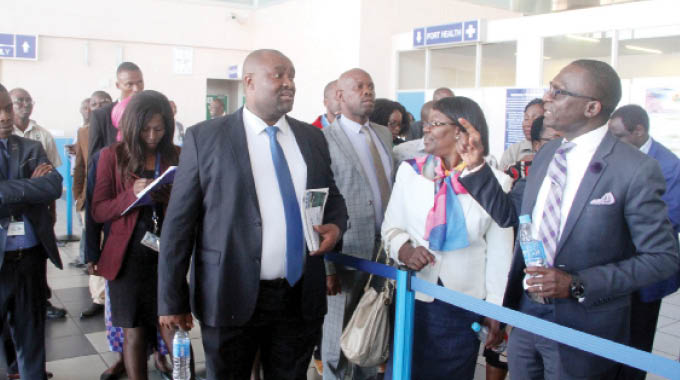 JM Nkomo Airport general manager, Mr Passmore Dewa, stresses a point to the chairman of the Parliamentary Portfolio Committee on Transport, Hon Oscar Gorerino (centre) during a tour of JM Nkomo International Airport in Bulawayo yesterday. Looking on is the Civil Aviation Authority of Zimbabwe Acting Director General Mrs Margaret Mantiziba (with scarf) and other Parliamentary Portfolio Committee on Transport members. (Picture by Nkosizile Ndlovu)