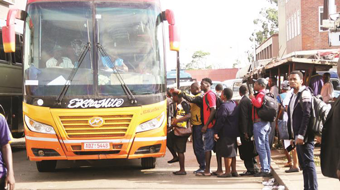 Commuters queue to board a bus after work at the Charge Office bus terminus in Harare (Picture by Edward Zvemisha)