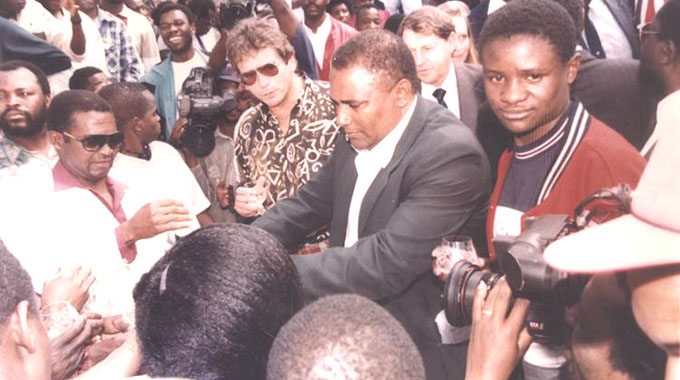 A BYGONE ERA . . . Vitalis “Digital’’ Takawira (right) in the company of the late Dream Team manager Jimmy “Daddy’’ Finch (second from right) and late coach Reinhard Fabisch as fans mob them in Harare in 1993