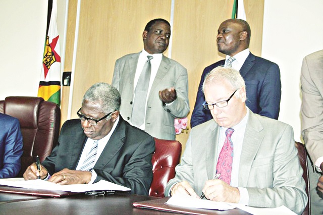 Then Mines and Mining Development Minister Walter Chidhakwa (second from back row) witnesses a memorandum agreement, flanked by Deputy Minister Fred Moyo (first at the back row), Zimbabwe Mining Development Corporation board chairman David Murangari and Kelltech director Keith Liddel in Harare (Picture by Tariro Kamangira)