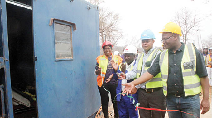 Insiza District Development Coordinator, Mr Zacharia Jusa (third from left) cuts the ribbon during the commissioning of Hawkline Mine processing plant in Filabusi, Insiza District in Matabeleland South last Thursday. Following proceedings (from left) are Hawkline Mine proprietor Mrs Kundai Chikonzo, Matabeleland South Deputy Provincial Mining Director Engineer Khumbulani Mlangeni and the Head of Gold development Initiative Fund (GDIF) from Fidelity Printers and Refiners Mr Matthew Chidavaenzi (right). — Picture by Nkosizile Ndlovu