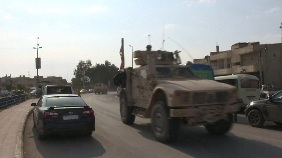 US troops pass through Tal Tamer before a convoy of ambulances arrives from Ras al-Ain