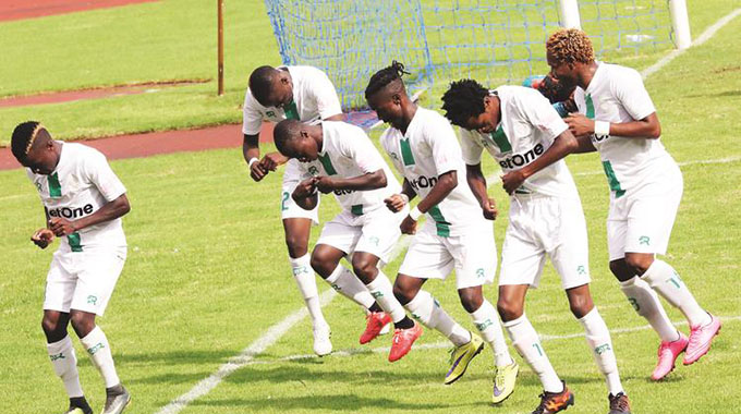 HAPPY PEOPLE . . . CAPS United players join in celebrating their second goal against Yadah at the National Sports Stadium yesterday