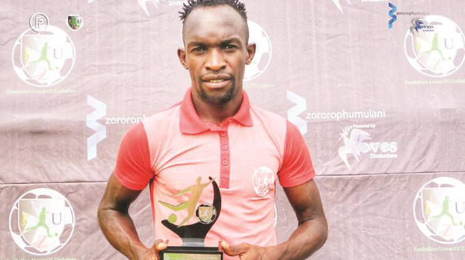 EARLY CHRISTMAS PRESENT . . . Triangle captain Ralph Kawondera displays the award he received at Gibbo yesterday after being named the Footballers Union of Zimbabwe Player of the Month for October