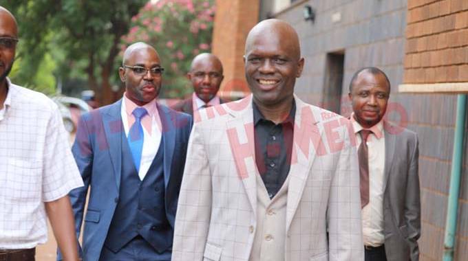ZIFA president Felton Kamambo (right) arrives at Rotten Row courts with Phil Machana (left0 yesterday