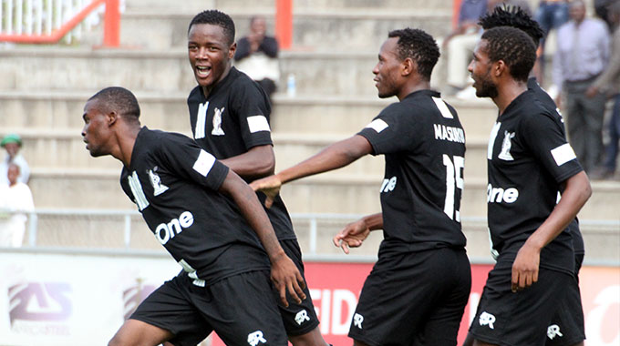 Highlanders FC players celebrate with Godfrey Makaruse (center) after he scored the team's 2nd goal during the Premier Soccer League match played at Babourfields stadium. (Picture by Nkosizile Ndlovu)