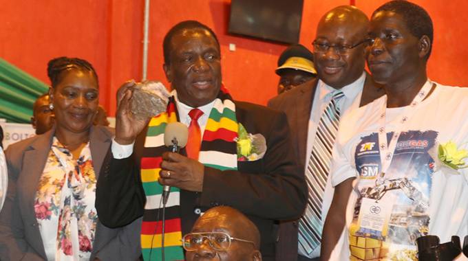 President Mnangagwa addresses delegates while flanked by Mines and Mining Development Minister Winston Chitando (second from right) and Zimbabwe Miners Federation president Henrietta Rushwaya (left) at the Mining indaba held at the Gweru Convention Centre.— Picture: Obey Sibanda