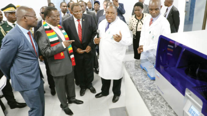 Nust DNA centre director Mr Zephania Dlamini stresses a point to the Nust chancellor President Mnangagwa during a tour of the university’s innovation hub last Friday. Looking on (from left) are Professor Amon Murwira, university council chairperson Mr Alvord Mabhena, and Minister of State for Bulawayo Provincial Affairs Cde Judith Ncube